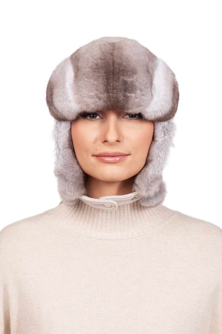 Fluffy beige chinchilla fur trapper hat with a chin strap for autumn and winter time.