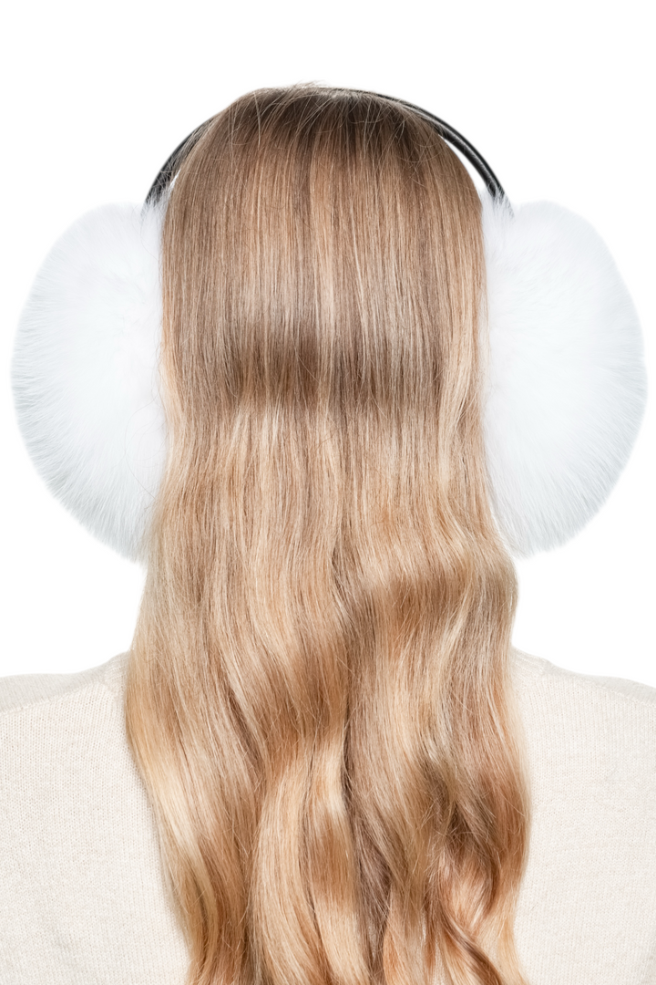 Model wearing soft real white fox fur earmuffs, cosy and stylish ear warmers for cold winter days.