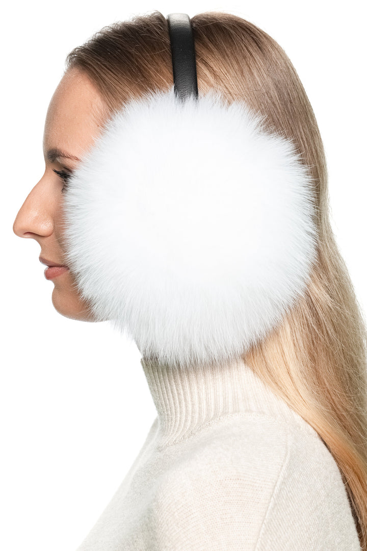 Handmade white fox fur earmuffs, fluffy and warm ear warmers styled as a Christmas gift for women.