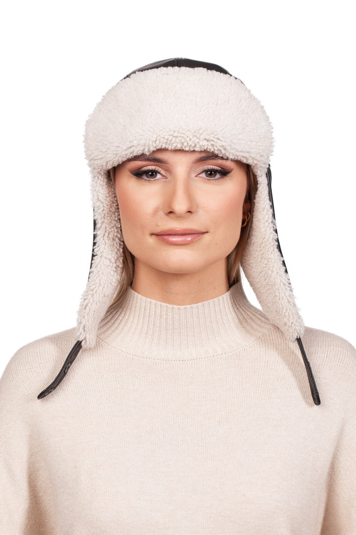 A person wearing the FurbySD White Shearling Fur Aviator Bomber Hat and a cream-colored sweater, posing against a plain white background.