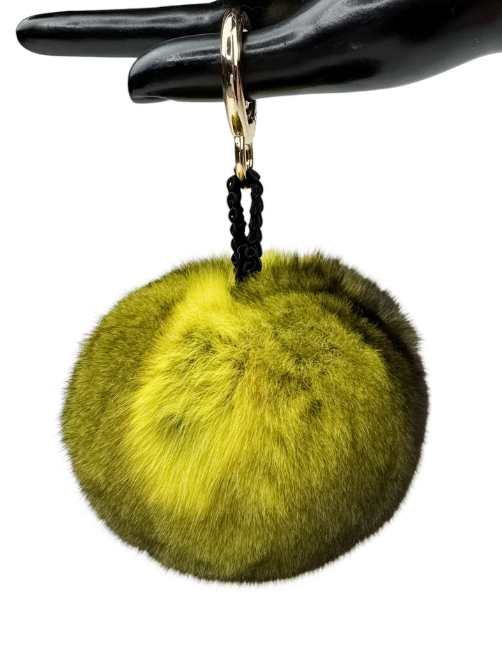 A luxurious accessory from FurbySD, this fluffy lime green pom-pom keychain is inspired by the Yellow Chinchilla Fur Bag Charm and adds a vibrant touch to the black mannequin hand with its easy-to-use metal clasp.