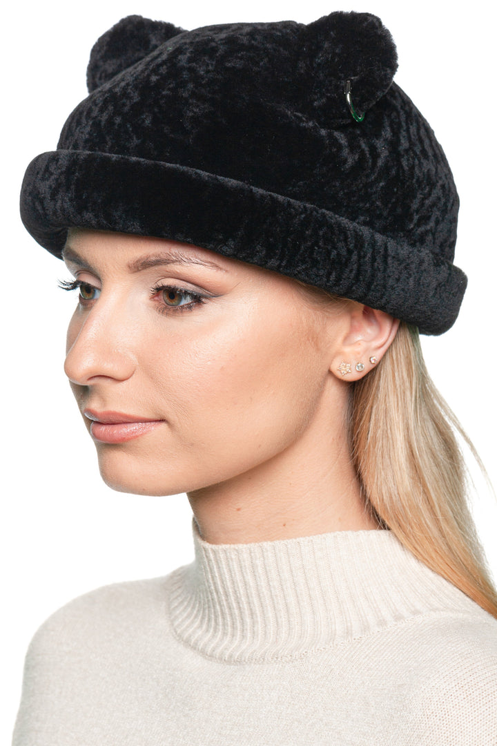 Side profile of woman in black lamb fur beanie hat with bear ears, real fur autumn winter fashion