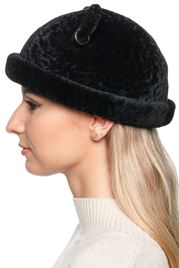 Side view of handmade black lamb fur beanie with rolled brim, luxury unisex winter hat.