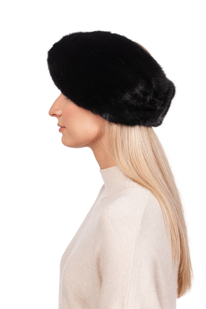 A woman with long blonde hair wears a Black Mink Fur Headband by FurbySD. She is in profile, facing left, dressed in a cream-colored sweater against a white background.