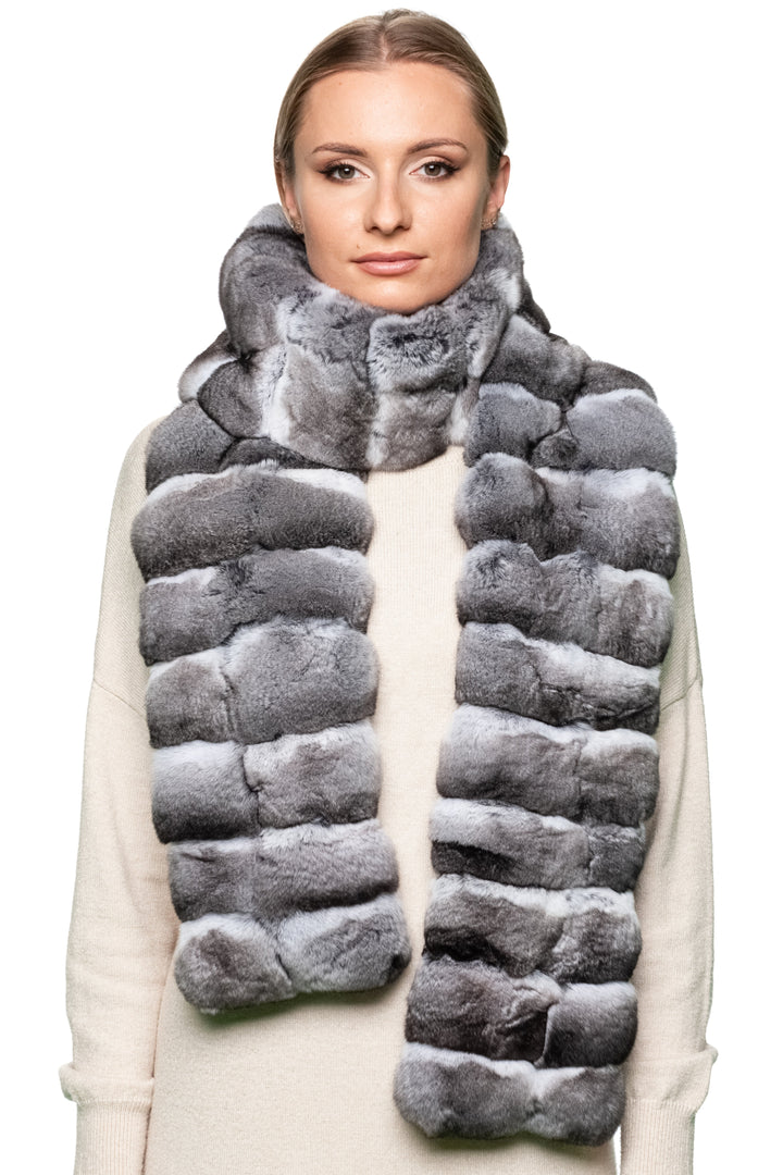 Layered wrap – woman wearing long striped chinchilla fur scarf wrapped twice, cozy luxury unisex winter accessory.