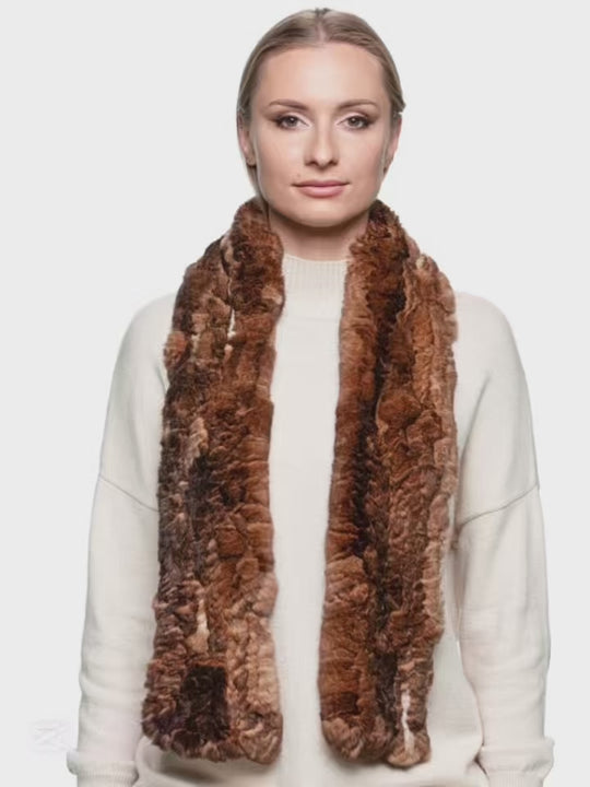 Woman wearing a long brown rex rabbit fur knitted scarf, handmade from real soft fur, styled over a cream sweater — luxury winter scarf for women.