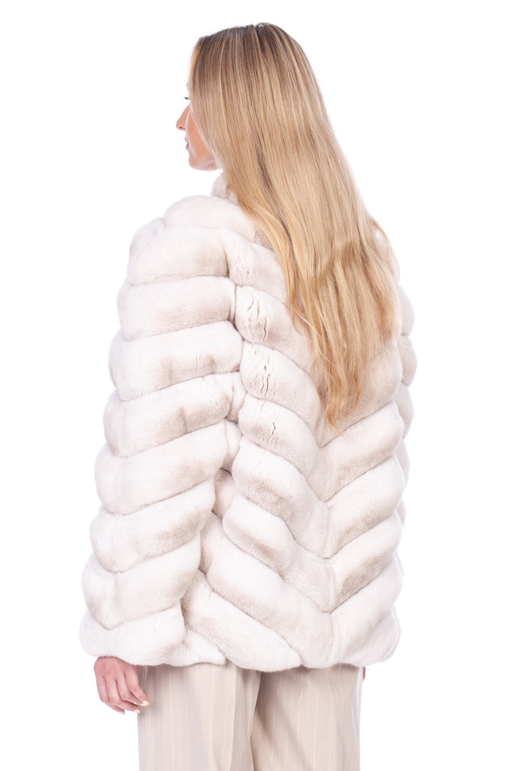 A person with long blonde hair is shown from the back, draped in a Cream Chinchilla Fur Coat by FurbySD and beige wide-legged pants. They are standing against a white background, showcasing high-heeled shoes.