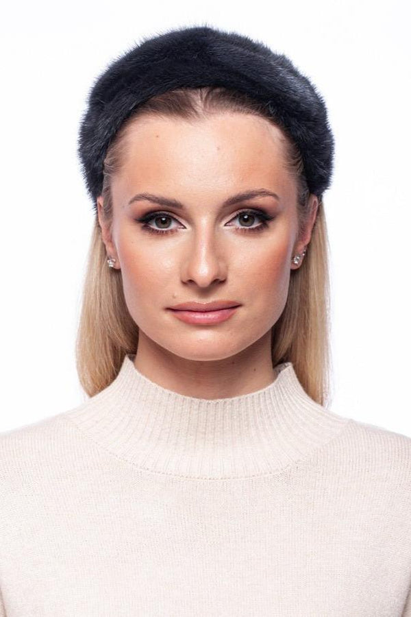 A woman with straight blonde hair wears a fluffy, handmade Grey Mink Fur Hairband by FurbySD and a light beige turtleneck sweater. She has a neutral expression and is positioned against a plain white background.